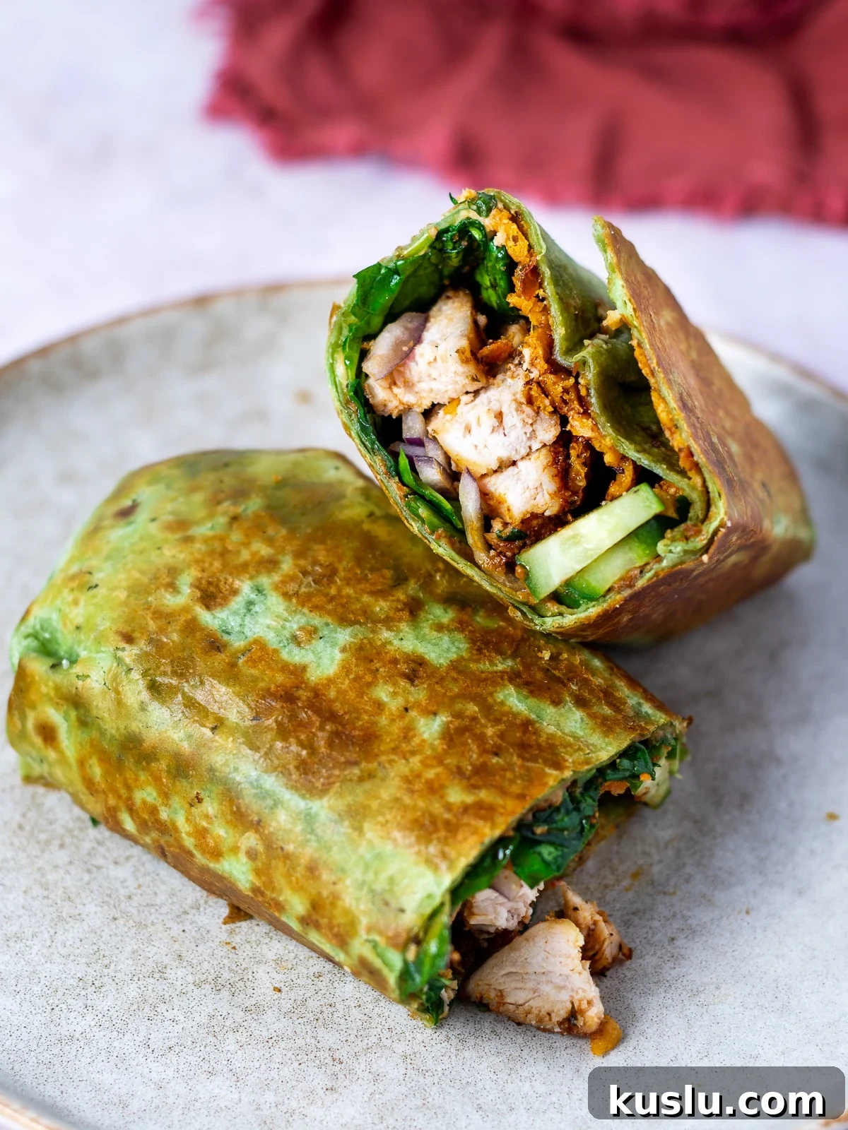 Two halves of a chicken hummus wrap