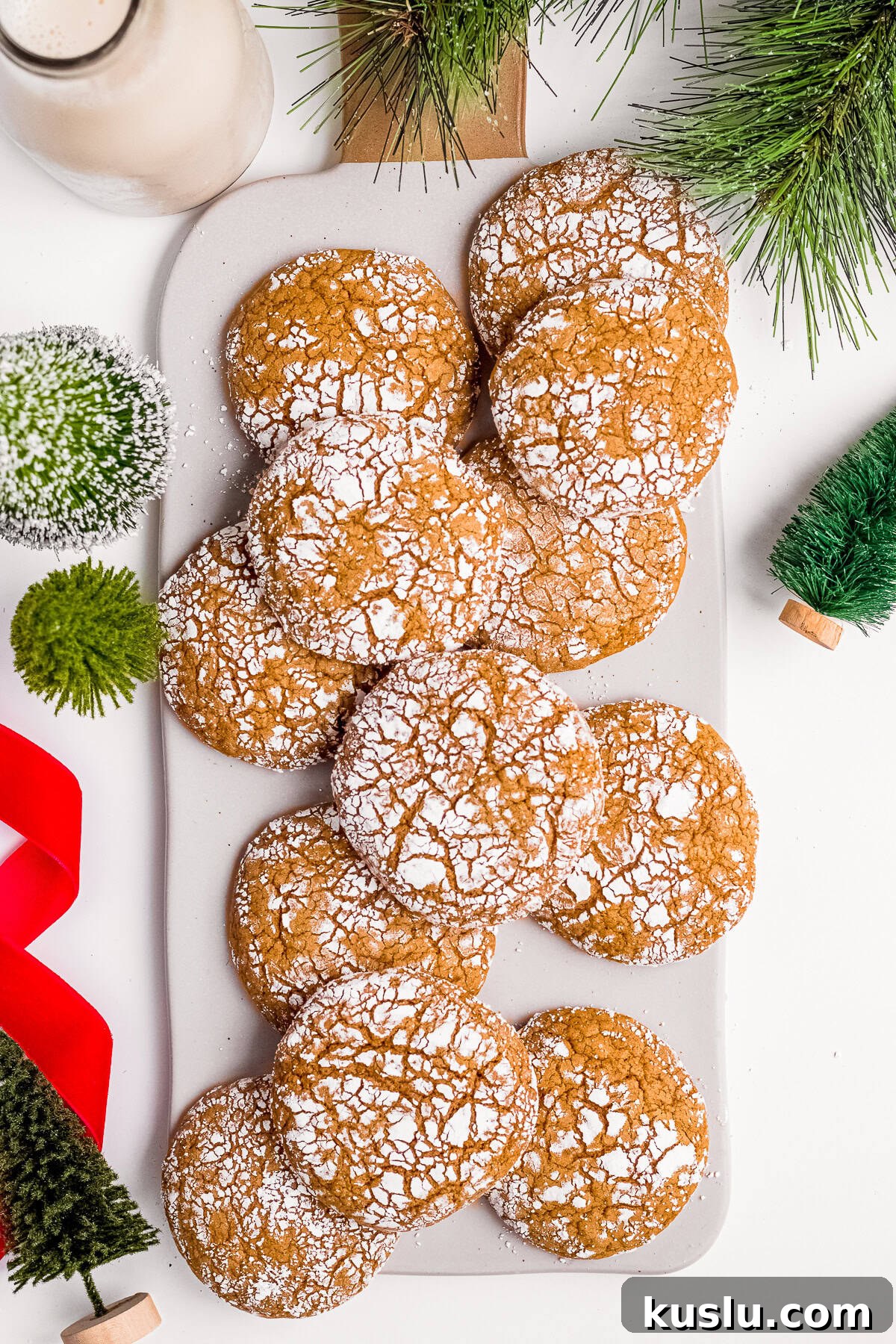 Overhead of Molasses Crinkle Cookies staked on white board.