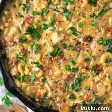 overhead shot of mac and cheese with chicken in skillet