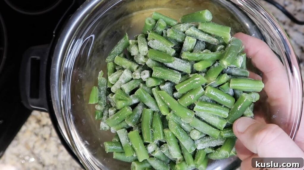 Instant Pot White Minestrone Soup Recipe for Quick Comfort 12 Adding green beans to pot