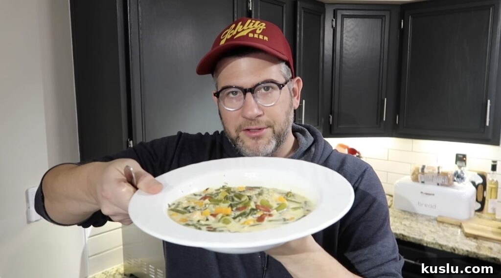 Instant Pot White Minestrone Soup Recipe for Quick Comfort 24 Man holding bowl of soup