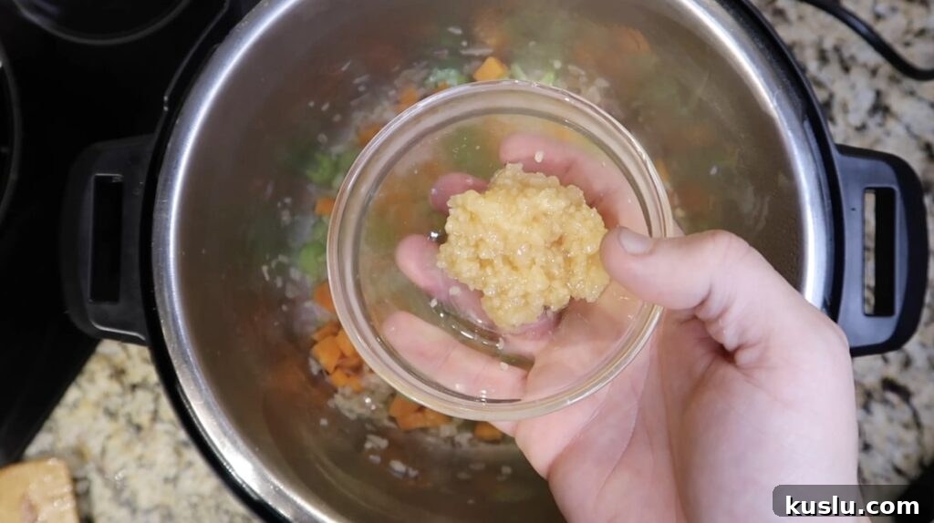 Instant Pot White Minestrone Soup Recipe for Quick Comfort 7 Adding garlic to pot