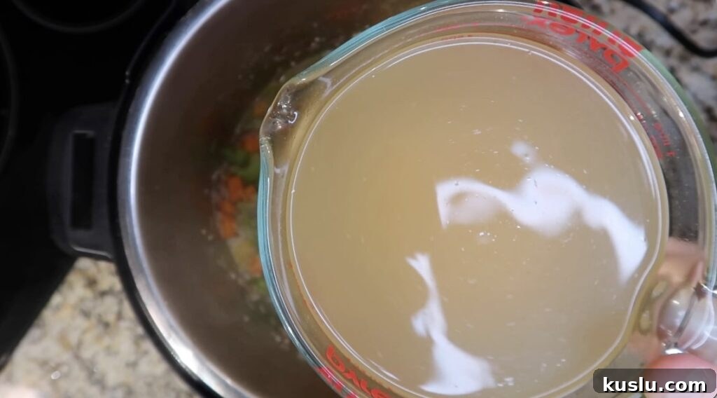 Instant Pot White Minestrone Soup Recipe for Quick Comfort 9 Adding broth to pot