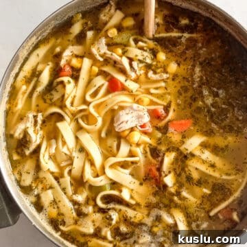 a large pot of chicken corn noodle soup.