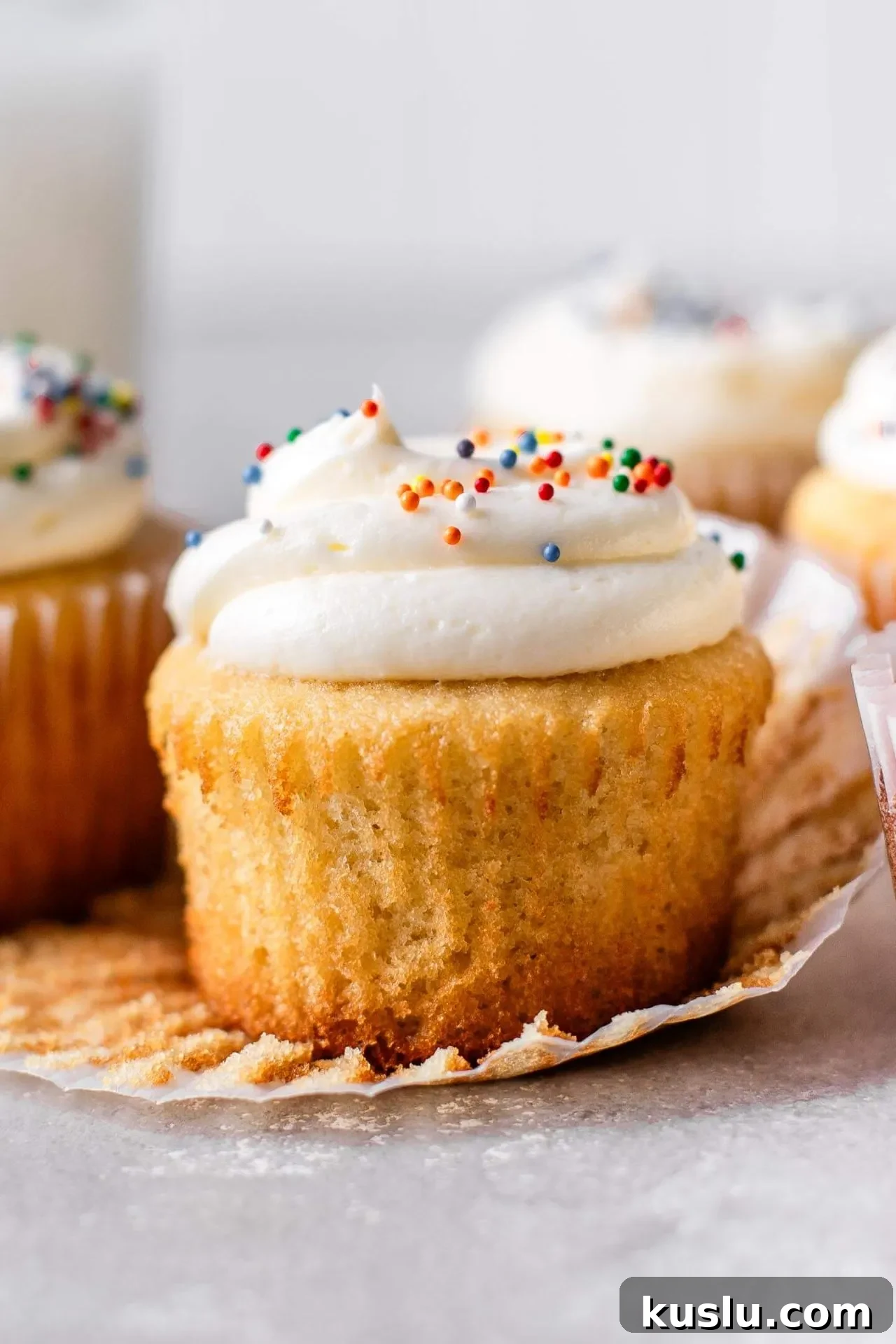 Classic Vanilla Cupcakes Recipe for Perfect Moist Cupcakes 6 frosted best vanilla cupcakes on table