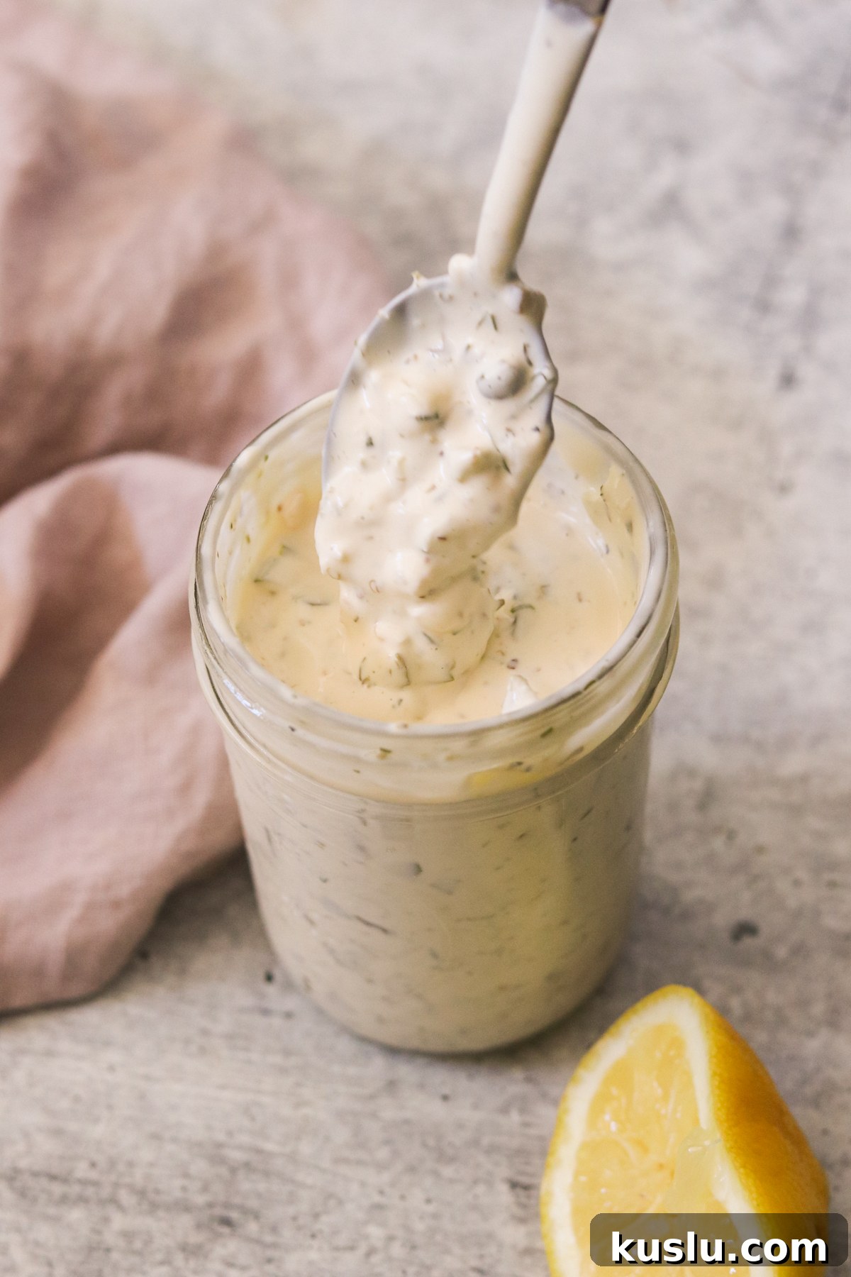 Homemade Tartar Sauce Recipe That Tops Store-Bought Options 2 a homemade tartar sauce recipe in a mason jar with a spoon