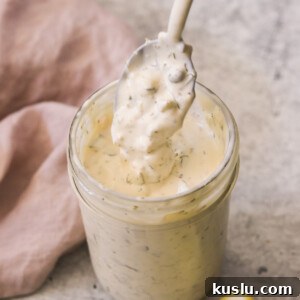 Homemade Tartar Sauce Recipe That Tops Store-Bought Options 7 a homemade tartar sauce recipe in a mason jar with a spoon