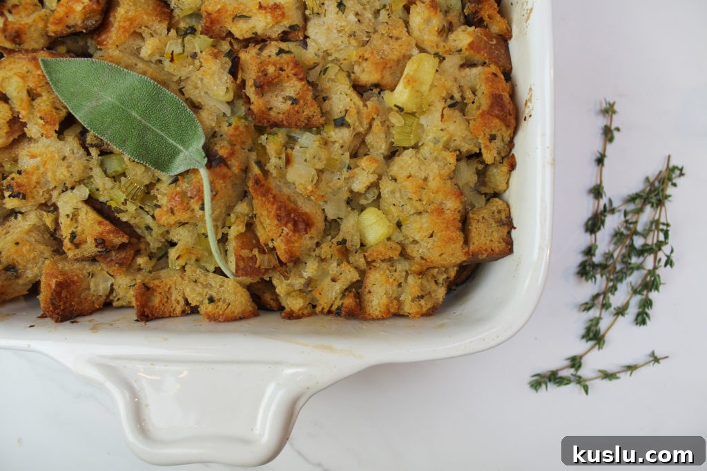 sourdough stuffing in white baking dish with thyme and sage