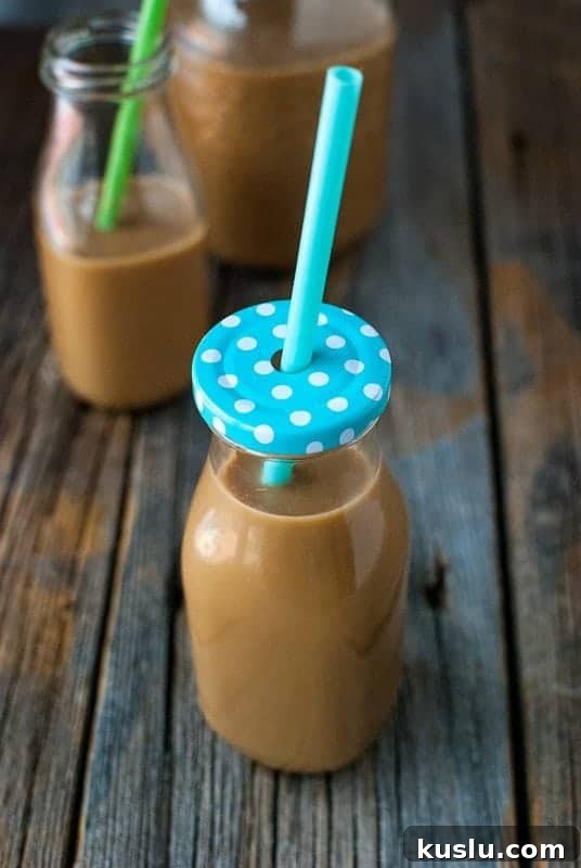 glass jar with lid and straw filled with starbucks frappuccino 