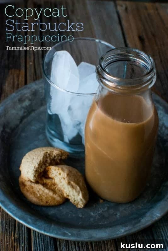 copycat starbucks frappuccino over a glass jar, glass of ice, and cookies