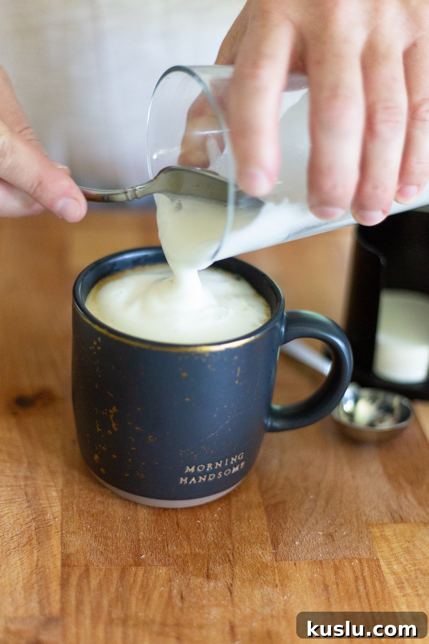 adding foamed milk to a cappuccino