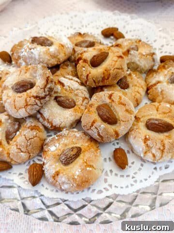 A glass plate with a pile of lemon amaretti biscuits.