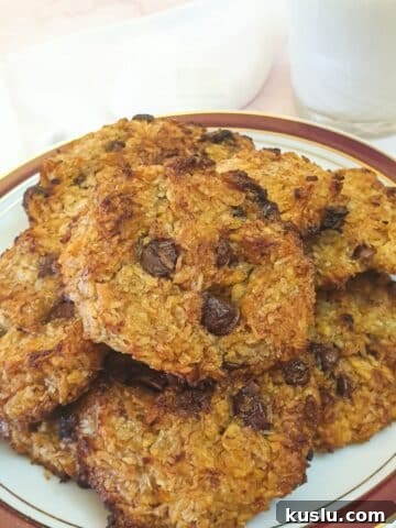 A plate of banana cornflake breakfast cakes with a glass of milk.