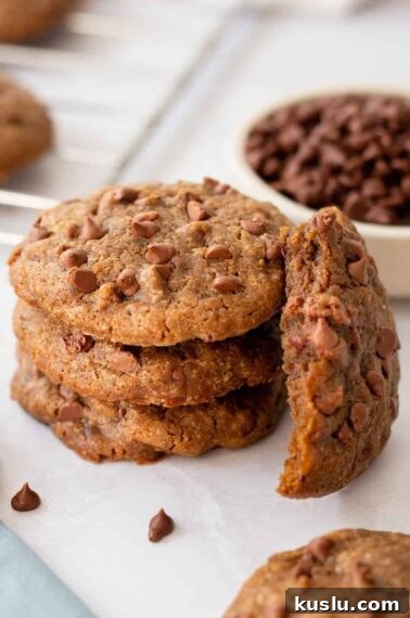 Chewy Chocolate Crinkle Cookies Recipe for Perfect Cracks 15 A stack of coffee cookies with one next to it missing a bite.