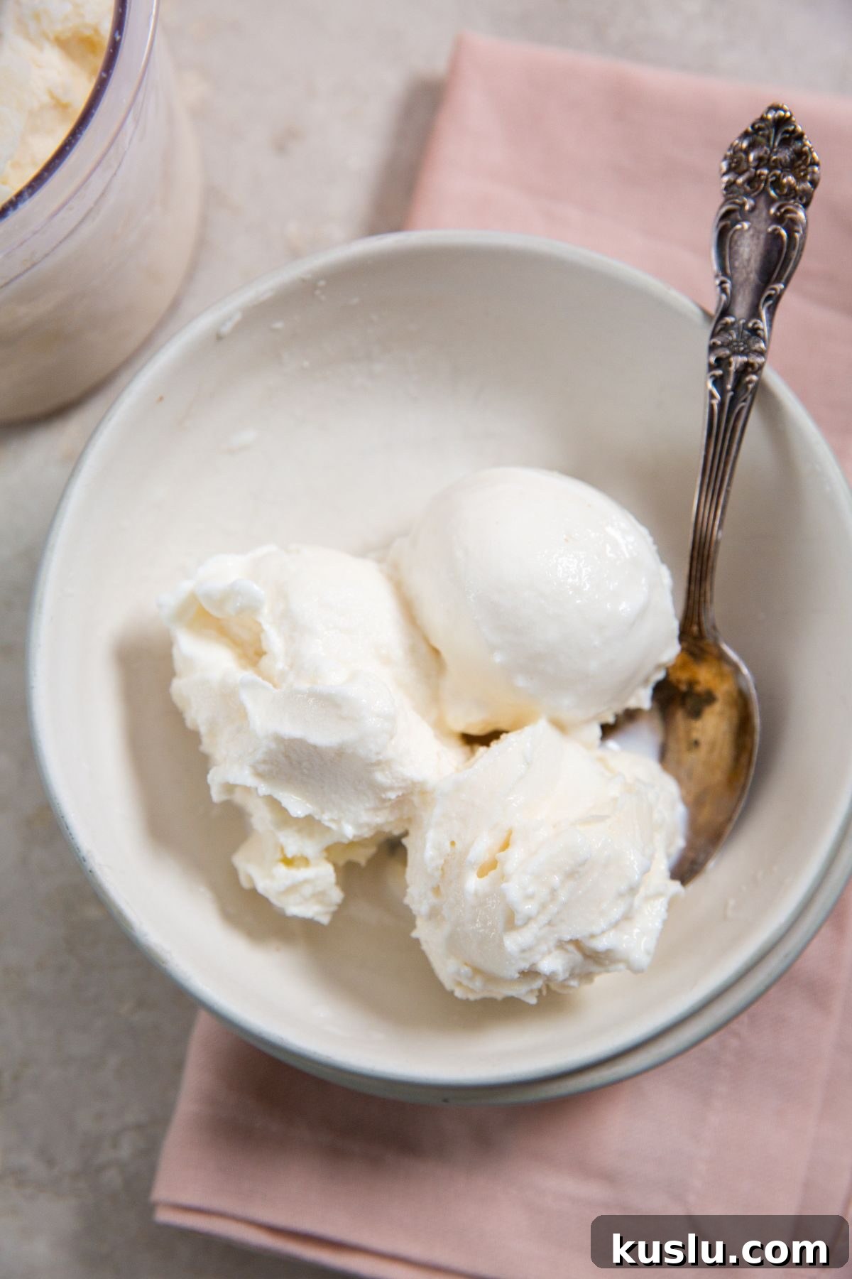 Ninja Creami Vanilla Ice Cream in a white bowl with a spoon and pink napkin