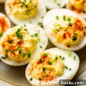 close up of several deviled eggs on a plate