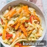 Jamaican Cabbage served in a white bowl with colorful cloth napkins