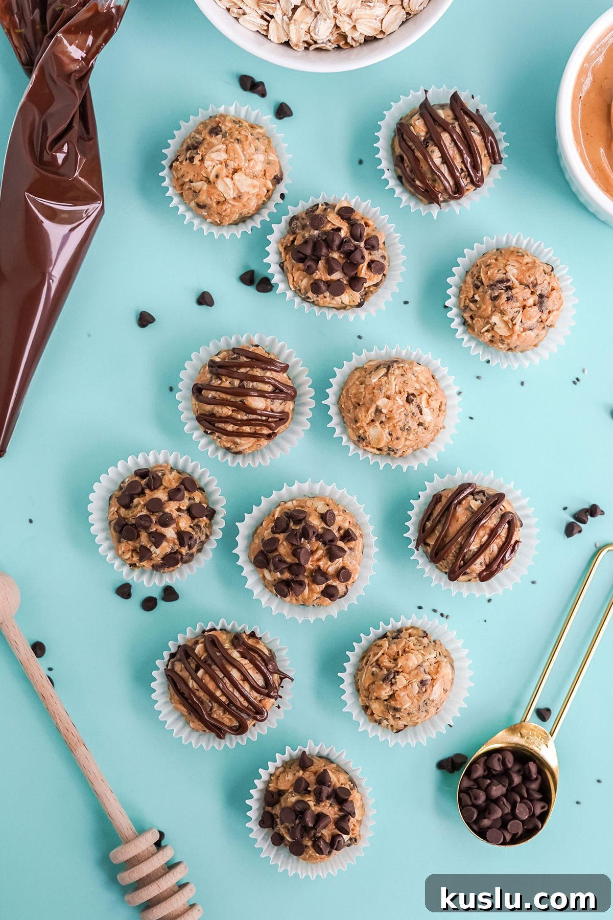 Peanut butter protein balls on the table with ingredients to make them.