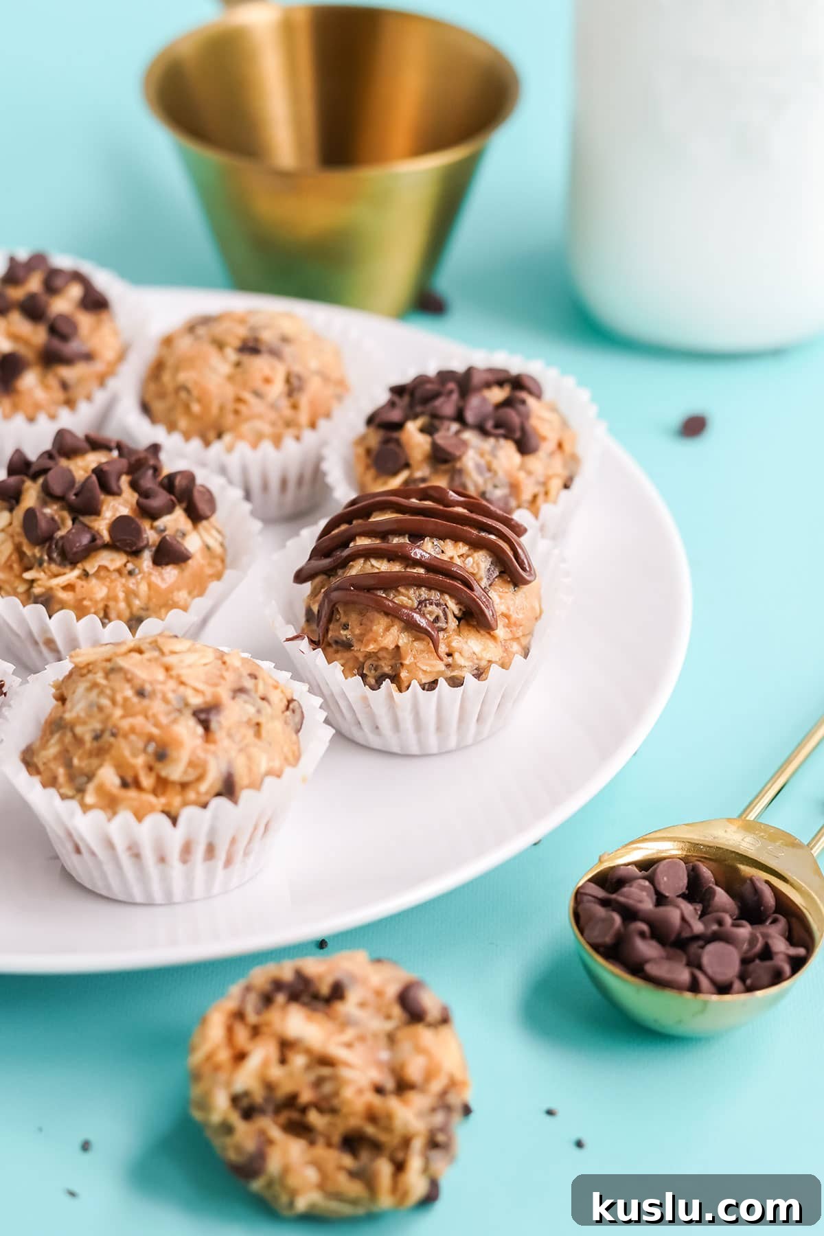 Protein balls with peanut butter on a plate with milk bottle.