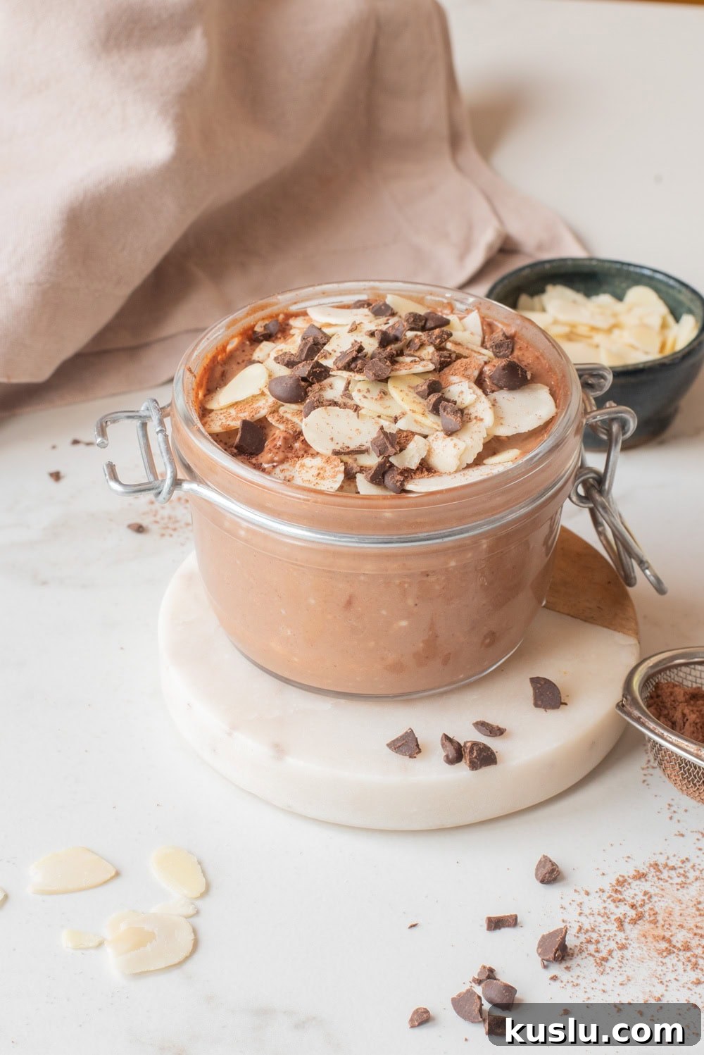Close-up of chocolate hemp power overnight oats with toppings in a jar.