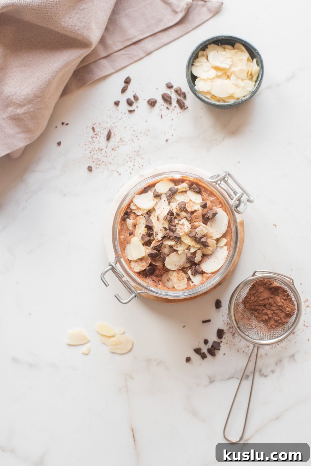 Chocolate hemp power overnight oats with toppings in a jar.