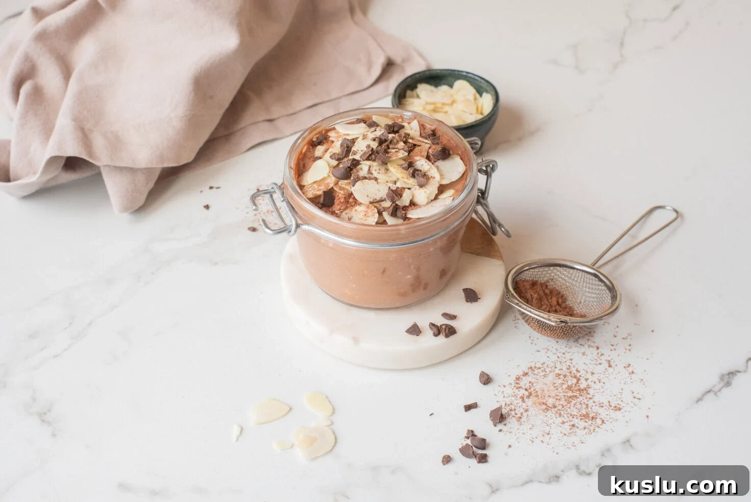 Chocolate hemp power overnight oats with toppings in a jar.