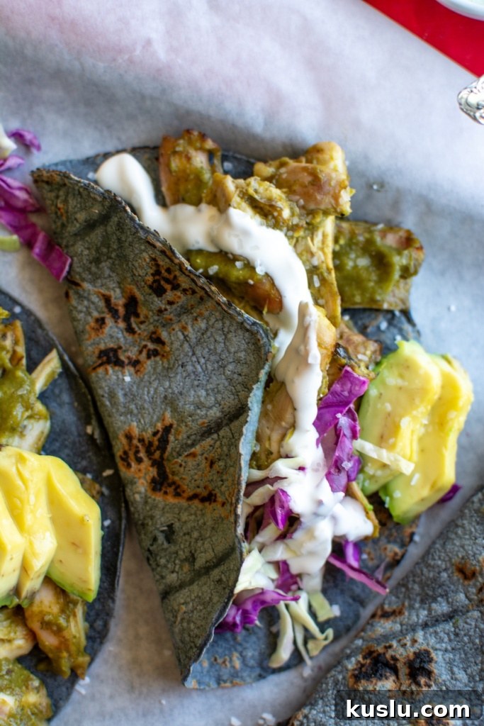 Sheet Pan Chili Verde Chicken Tacos Recipe for Quick Weeknight Meals 4 sheet pan chili verde chicken tacos on a piece of parchment paper