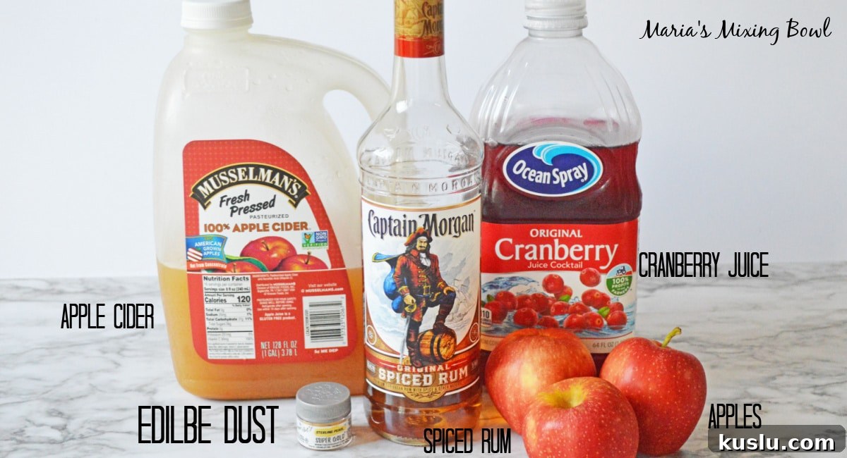 apple cider, spiced rum, cranberry juice, apples, and edible luster dust labelled with text