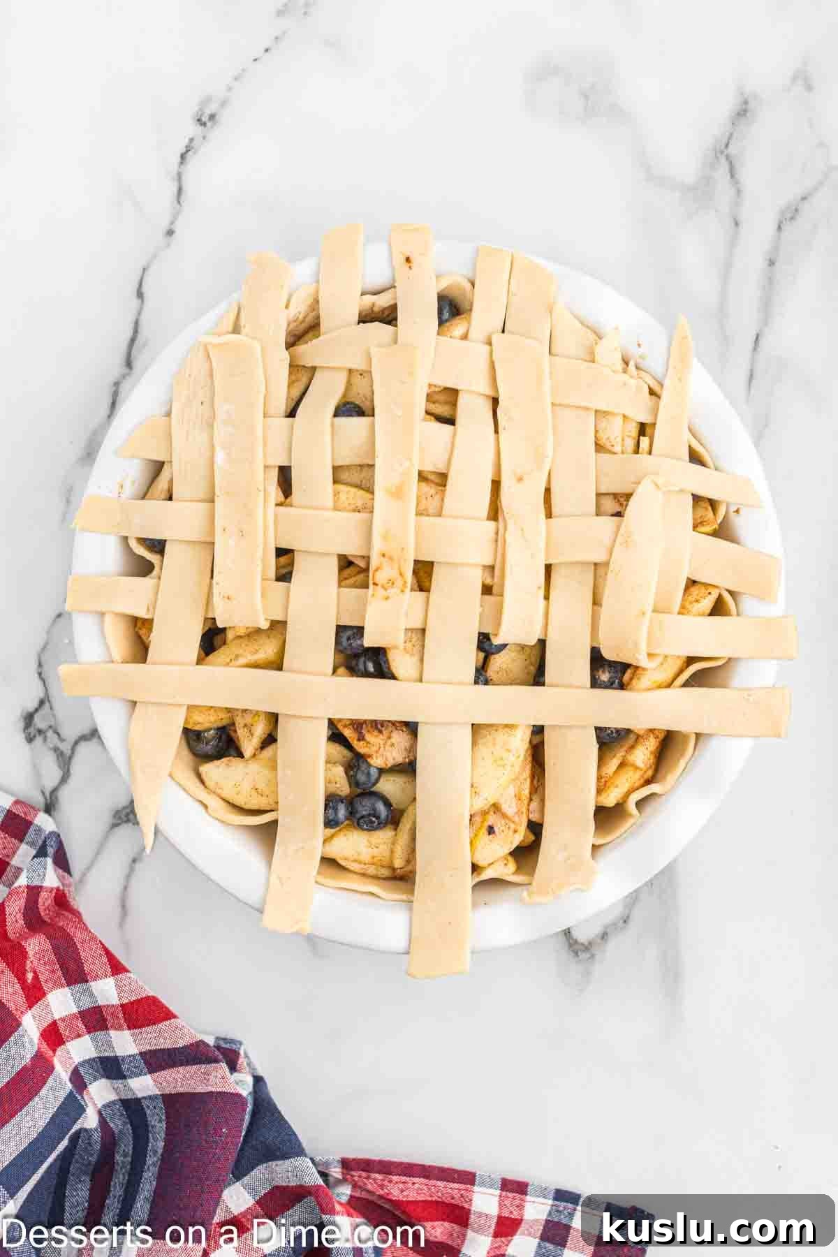 Apple and Blueberry Pie Recipe: Flaky Crust with Fresh Fruit Filling 5 Filling in pie crust topped with lattice.