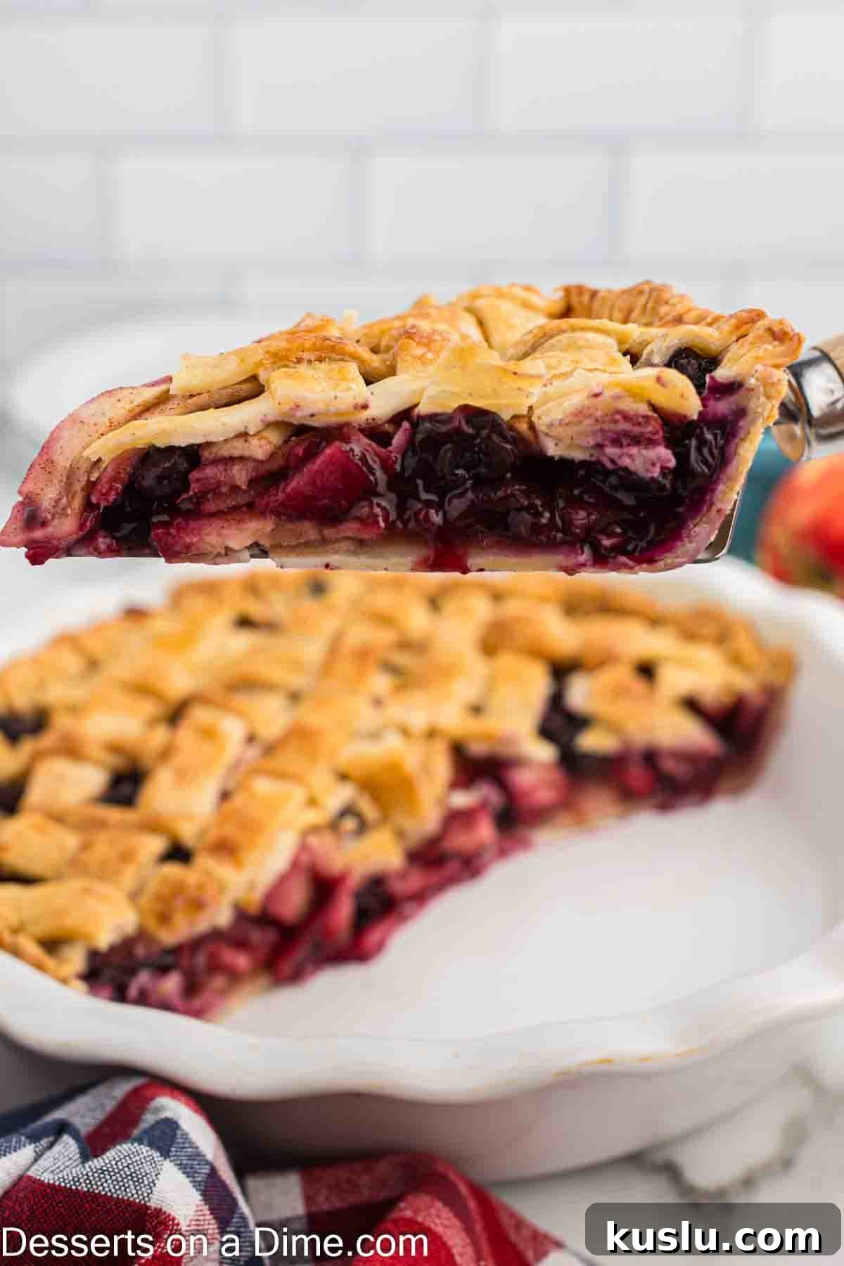 Apple and Blueberry Pie Recipe: Flaky Crust with Fresh Fruit Filling 8 Apple Blueberry Pie being sliced.