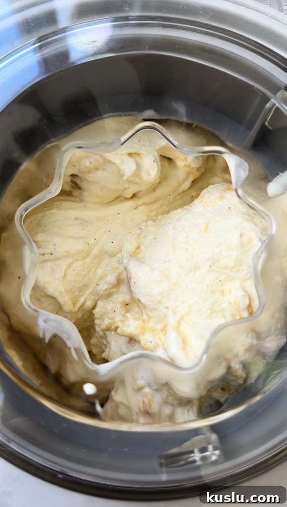 Creamy Homemade Peach Ice Cream Recipe for Summer 10 Overhead view of peach ice cream inside an ice cream maker.