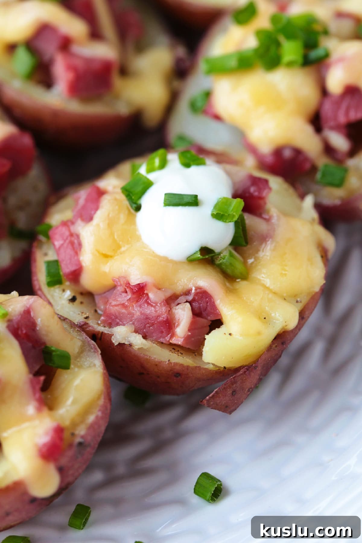 mini red potatoes stuffed with corned beef and cheese topped with sour cream