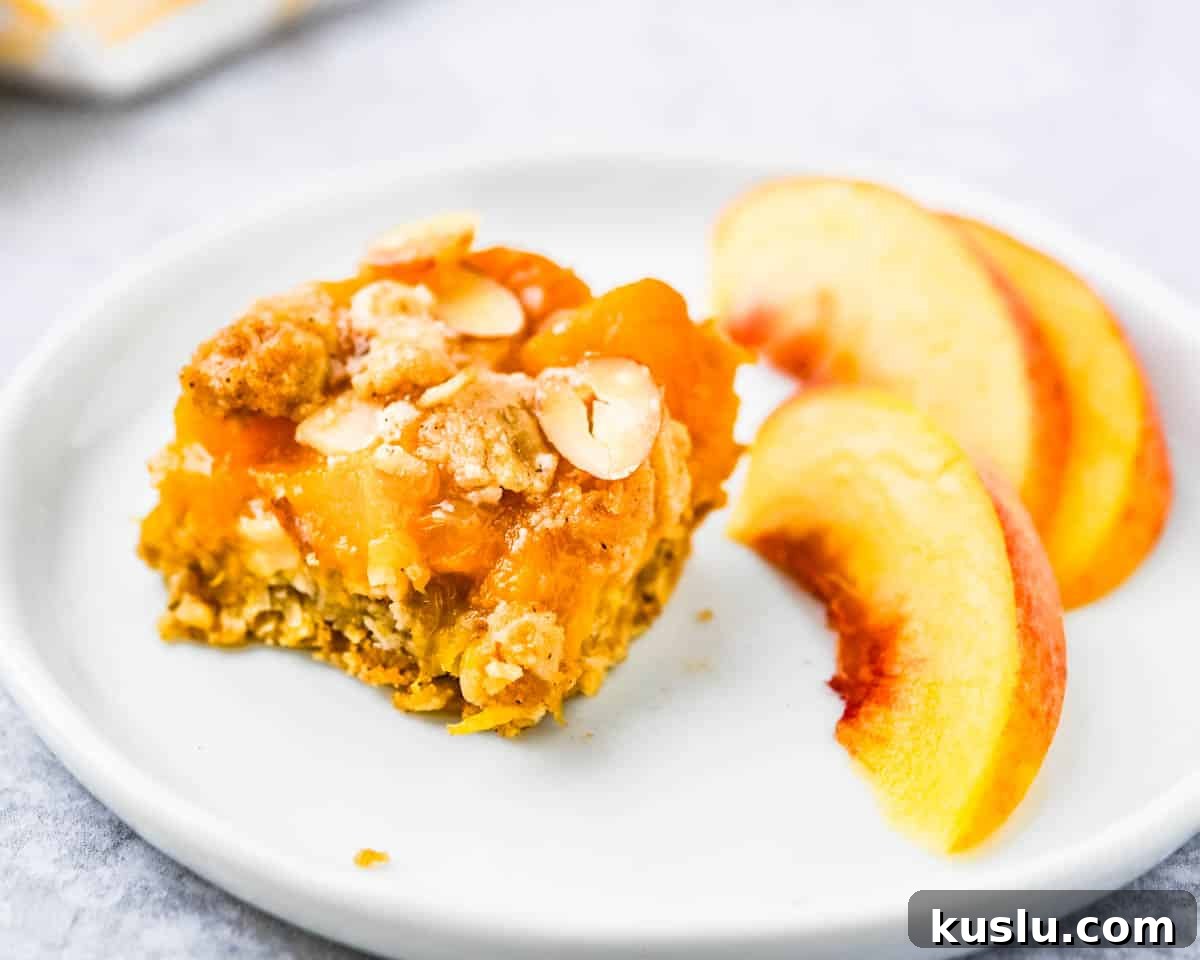 Serving a peach bar on a plate with a side of fresh peaches.