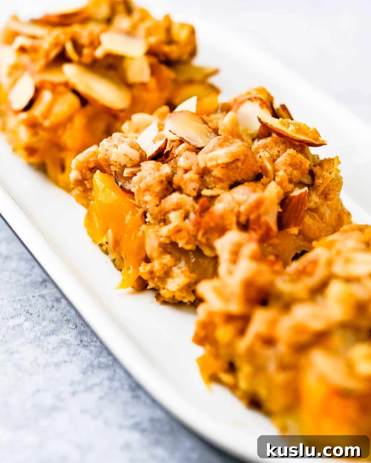 A plate of sliced peach crumble bars.