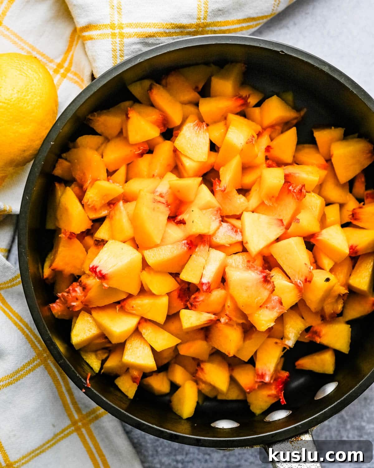 Freshly chopped peaches in a saucepan.