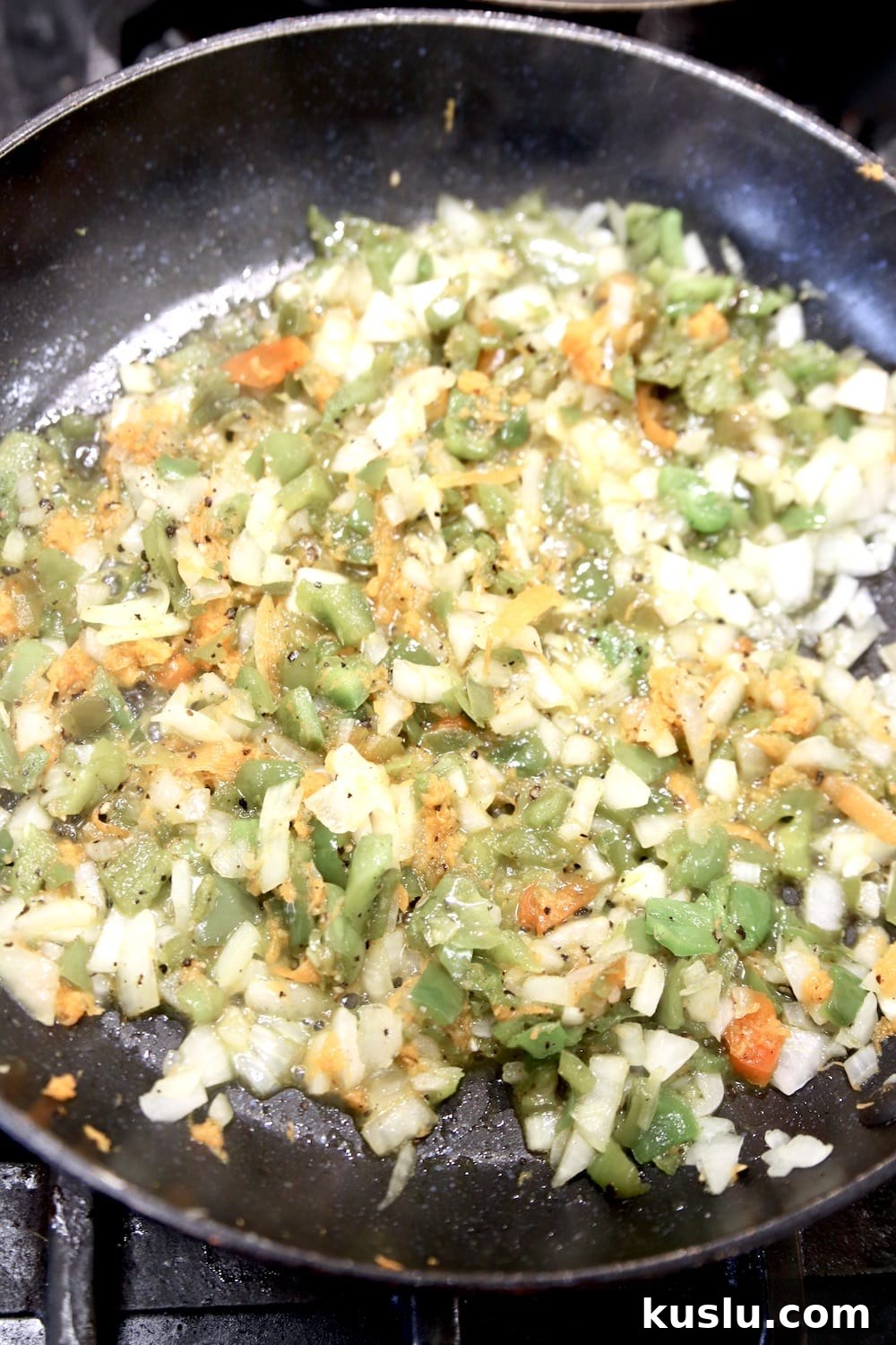 Making pizza sauce onions, bell peppers, carrots in a skillet