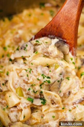 a spoonful of cheesy instant pot philly cheesesteak pasta