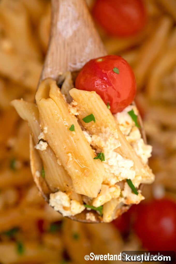 Instant Pot feta pasta on a wooden spoon.