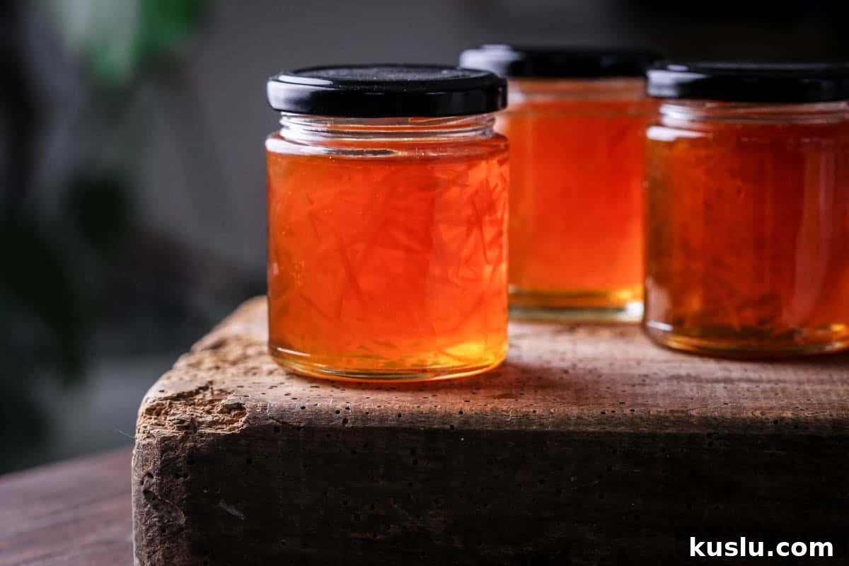 Jar of marmalade showing clear set and peel suspended throughout.