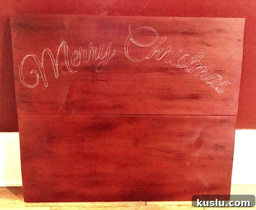 Words lightly traced onto painted wood with a white pencil.