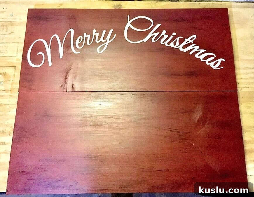 Merry Christmas painted onto front top of sign.