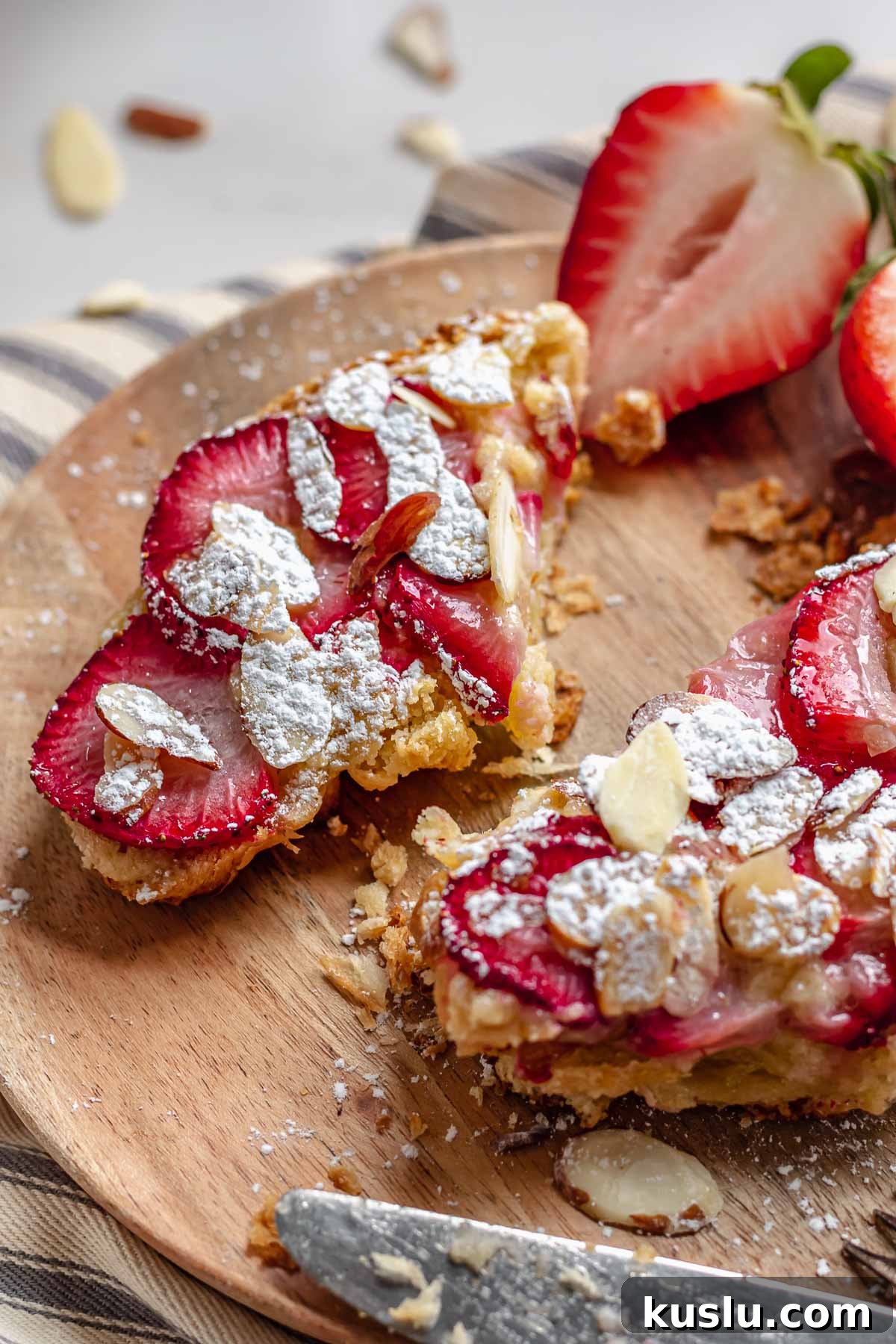 Strawberry Almond Bostock Made from Croissant Pastry 3 Bostock ripped apart to two pieces on a plate.