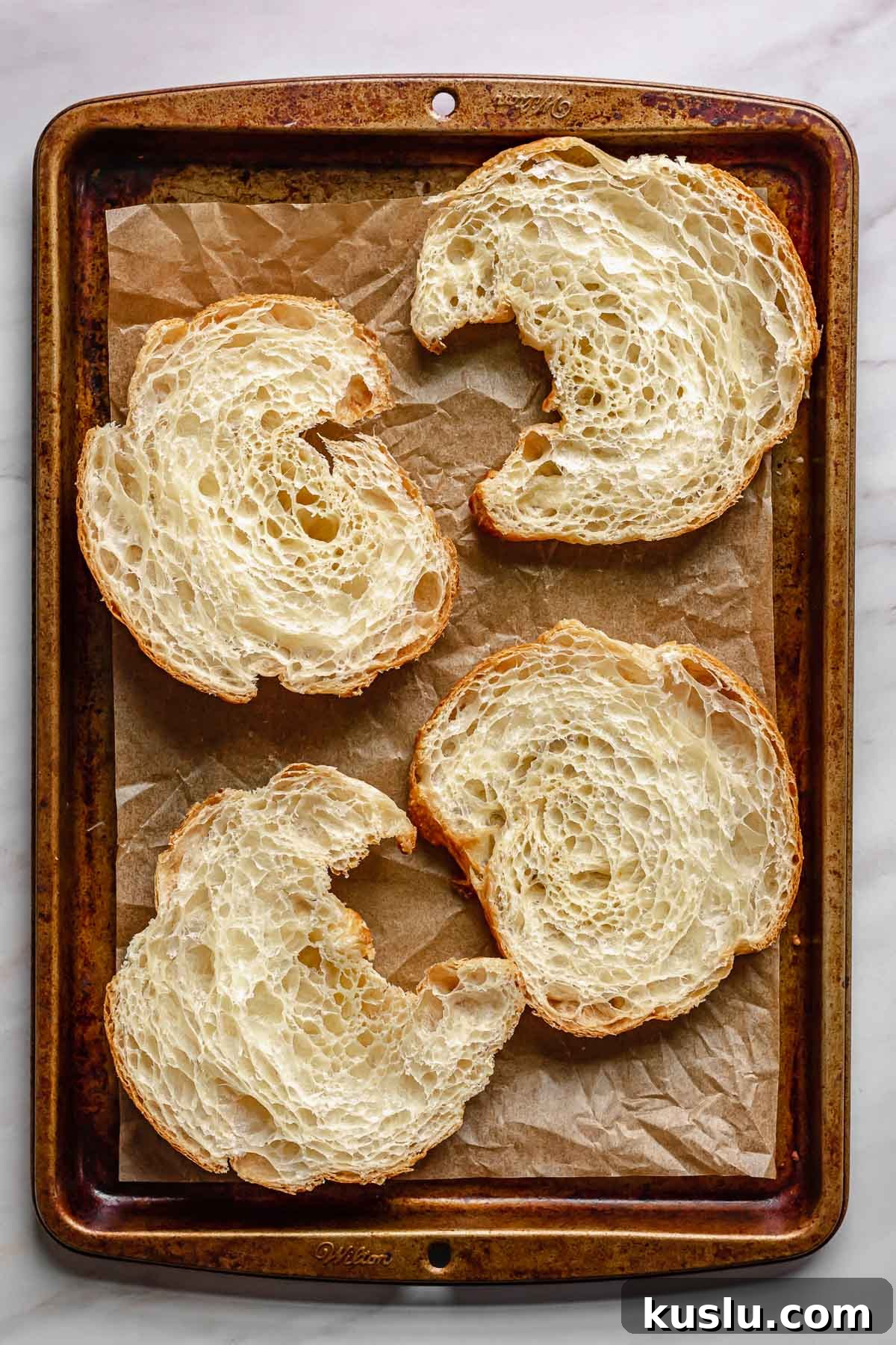 Strawberry Almond Bostock Made from Croissant Pastry 5 Split croissants on a baking sheet.