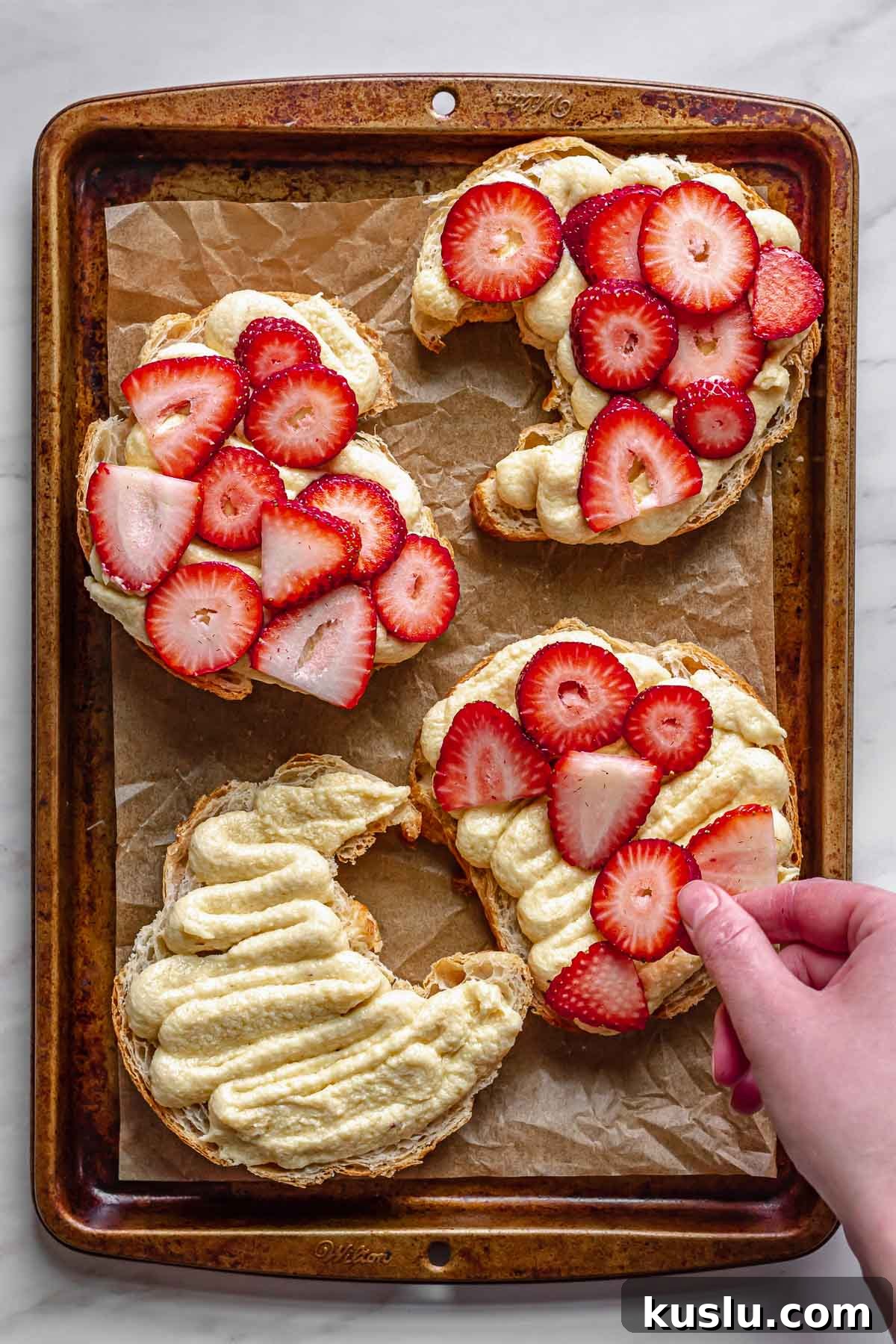 Strawberry Almond Bostock Made from Croissant Pastry 7 Sliced strawberries being added onto the frangipane.