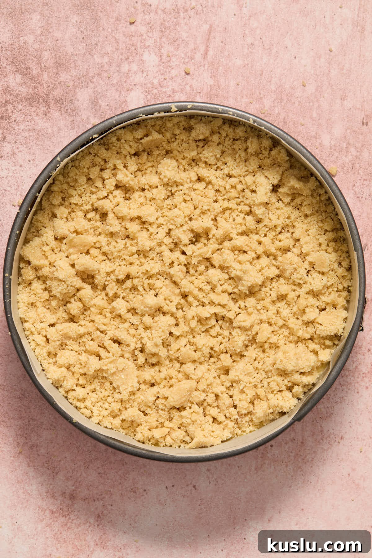 Chilled crumb topping scattered on top of cake batter in the pan.
