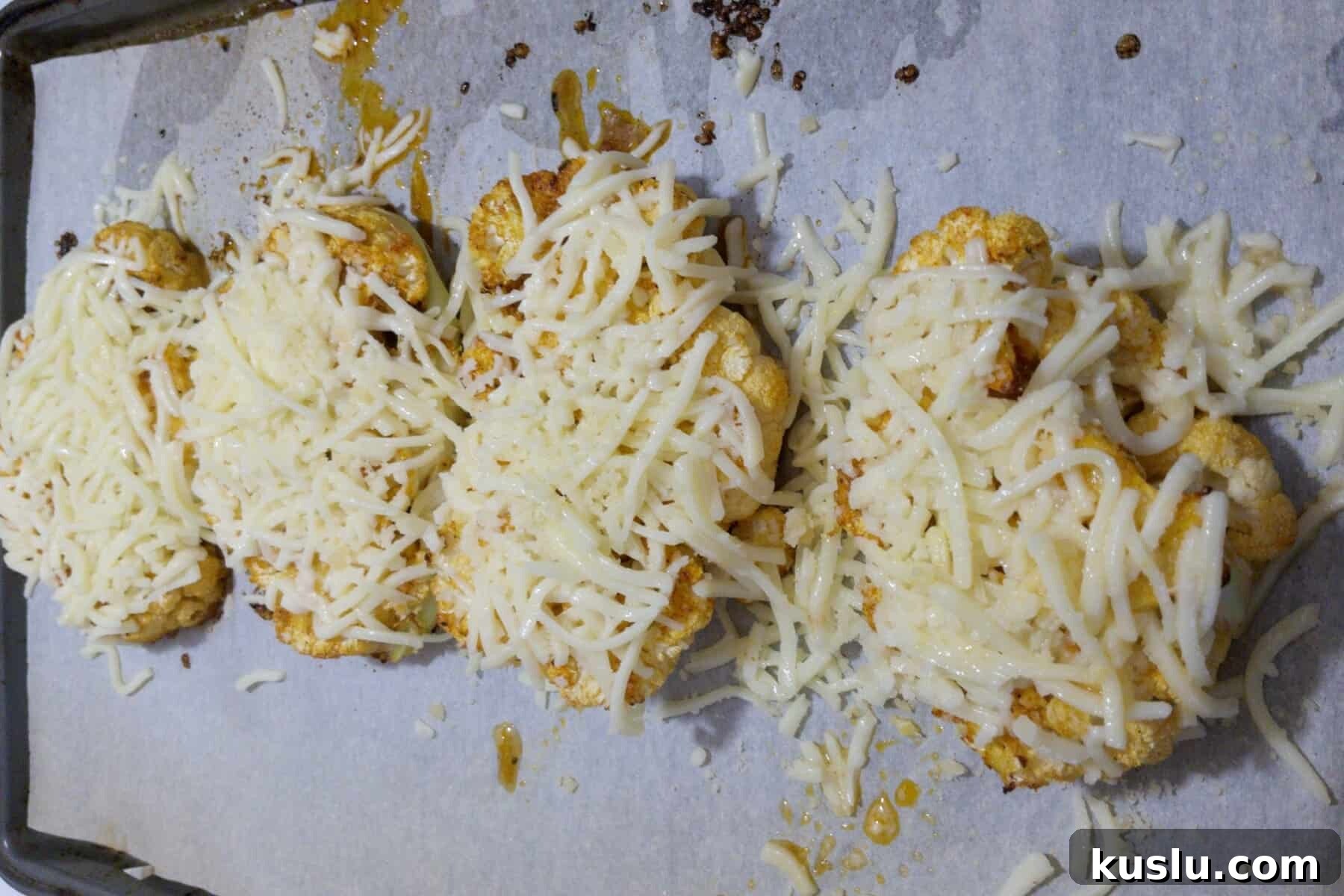 Cauliflower steaks covered in cheese to be melted