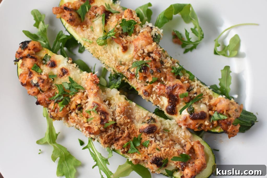 Italian Chicken Zucchini Boats Recipe — Savory Stuffed Zucchini 4 Two stuffed chicken zucchini boats with melted cheese and panko on top