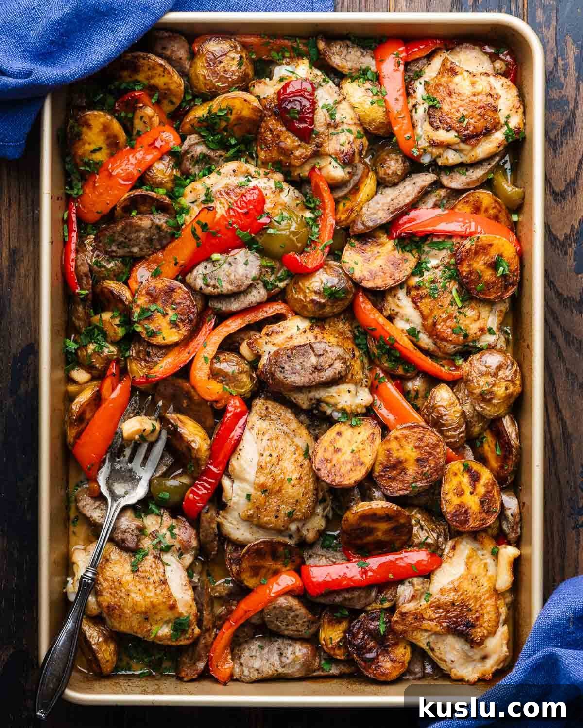 Savory Chicken Scarpariello Recipe: Zesty Italian Classic 2 Chicken Scarpariello in gold baking pan with serving fork.