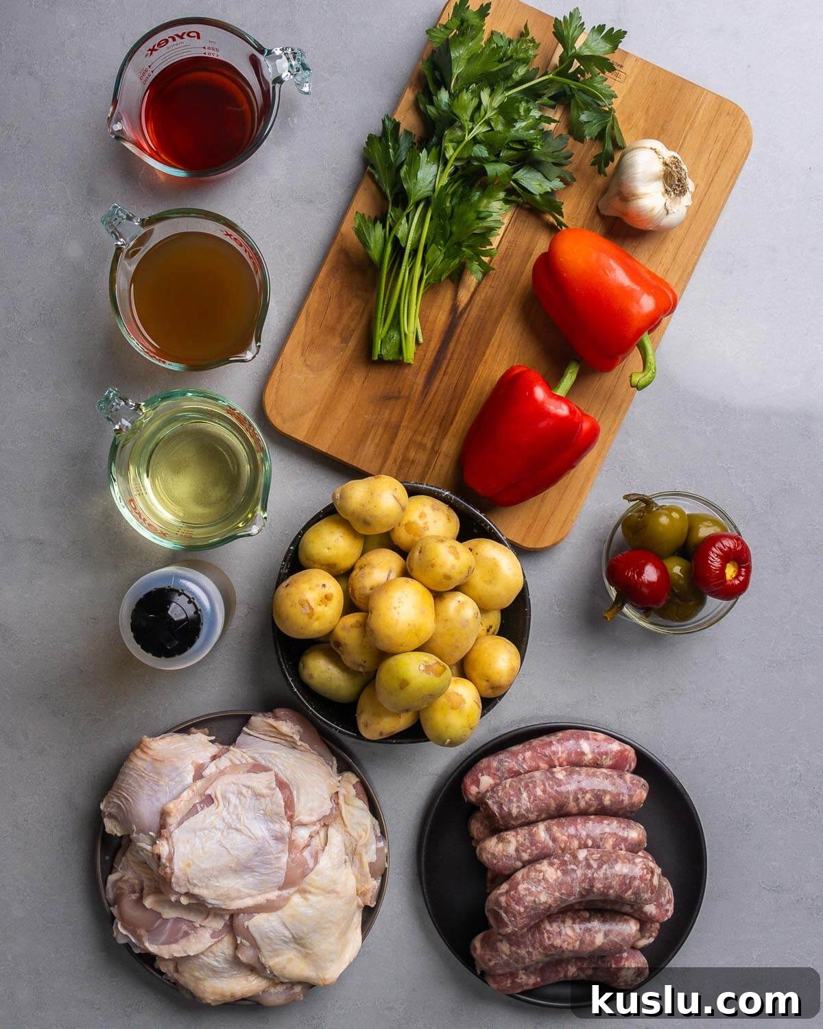 Savory Chicken Scarpariello Recipe: Zesty Italian Classic 3 Ingredients shown: red wine vinegar, chicken stock, white wine, olive oil, parsley, garlic, red bell peppers, potatoes, cherry peppers, chicken thighs, and Italian sausage.