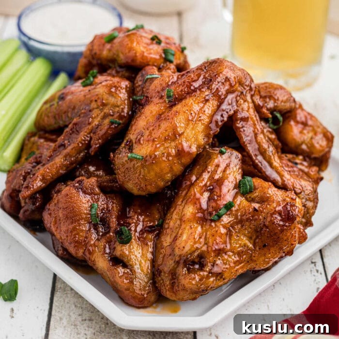 Closeup of finished glazed wings on a platter for the feature image.